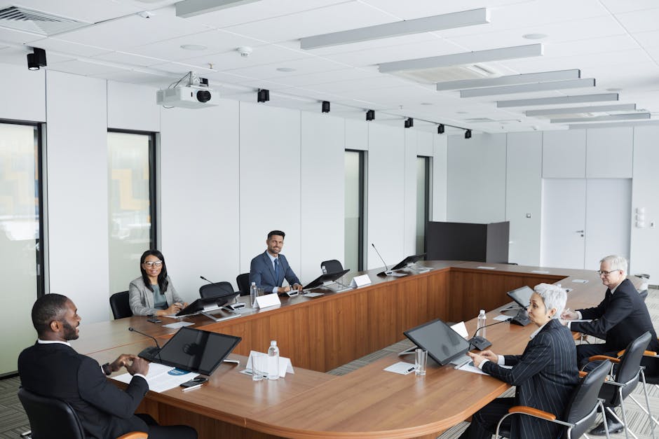 A multicultural group of professionals engaged in a business meeting in a modern conference room